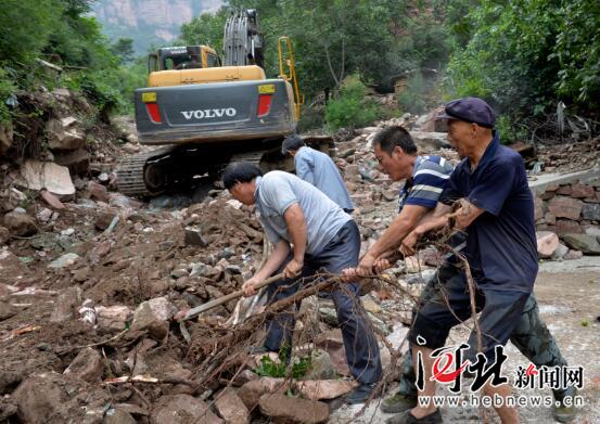 8月1日，在石家庄市赞皇县嶂石岩风景区内软枣会村村民们正在抓紧抢修被洪水冲毁的道路。